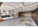 Spacious garage featuring custom storage cabinets and ample space for parking and projects at 10157 E San Salvador Dr, Scottsdale, AZ 85258