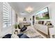 Cozy living room with plantation shutters, a comfortable seating area, and a stylish cabinet against the wall at 10157 E San Salvador Dr, Scottsdale, AZ 85258