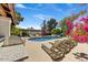 Relaxing pool area featuring chaise lounges, a built-in grill, and blossoming bougainvillea adding charm and color at 10157 E San Salvador Dr, Scottsdale, AZ 85258