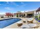 Inviting pool and patio area with comfortable seating, manicured landscaping, and a charming outdoor kitchen at 10157 E San Salvador Dr, Scottsdale, AZ 85258