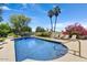 Sparkling swimming pool surrounded by lush landscaping, lounge chairs, and vibrant bougainvillea creating a serene retreat at 10157 E San Salvador Dr, Scottsdale, AZ 85258
