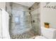 Shower featuring beautiful tiles, a glass shower door, and modern black fixtures at 11260 N 92Nd St # 2054, Scottsdale, AZ 85260