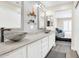 Modern bathroom with dual vessel sinks, glass shelving, and a view into the bedroom at 11260 N 92Nd St # 2054, Scottsdale, AZ 85260