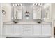 Bathroom vanity with dual vessel sinks, white cabinetry, and decorative mirrors at 11260 N 92Nd St # 2054, Scottsdale, AZ 85260