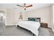 Modern bedroom with ceiling fan, gray carpet, minimalist furnishings, and ensuite bathroom at 11260 N 92Nd St # 2054, Scottsdale, AZ 85260