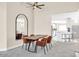 Elegant dining room with modern chairs, table, mirror, and adjacent kitchen view at 11260 N 92Nd St # 2054, Scottsdale, AZ 85260