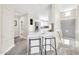 Hallway and kitchen view with breakfast bar and stool and modern stainless steel appliances at 11260 N 92Nd St # 2054, Scottsdale, AZ 85260