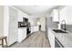 Bright kitchen featuring white cabinetry, stainless steel appliances, and stylish backsplash and wood flooring at 11260 N 92Nd St # 2054, Scottsdale, AZ 85260