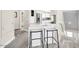 Stylish breakfast bar with seating next to a stairwell and open to a modern kitchen area at 11260 N 92Nd St # 2054, Scottsdale, AZ 85260