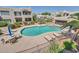 Inviting community pool surrounded by mature landscaping, lounge chairs, and desert homes at 11260 N 92Nd St # 2054, Scottsdale, AZ 85260