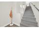 Carpeted stairway featuring neutral walls and a modern coat rack at 11260 N 92Nd St # 2054, Scottsdale, AZ 85260