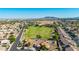 Birds eye view of a home near a green field and park in a well-maintained community with stunning mountain views at 1443 N Poppy St, Casa Grande, AZ 85122