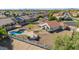 Aerial view showing house, pool, built in outdoor kitchen, landscaping, and neighborhood at 1443 N Poppy St, Casa Grande, AZ 85122