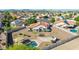 Aerial view of home with a pool, built-in BBQ, and mature desert landscaping at 1443 N Poppy St, Casa Grande, AZ 85122