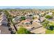 Aerial view of a home with a large private backyard, pool, patio and green landscaping in a Gathering-friendly neighborhood at 1443 N Poppy St, Casa Grande, AZ 85122