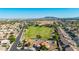 Aerial view of a residential area with a home located near a park and desert landscape at 1443 N Poppy St, Casa Grande, AZ 85122