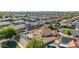 Aerial view of a home featuring a backyard pool, patio, and meticulously landscaped grounds in a neighborhood community at 1443 N Poppy St, Casa Grande, AZ 85122