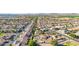 Expansive aerial view of a well-maintained community with lush landscaping, terracotta rooftops and solar panels at 1443 N Poppy St, Casa Grande, AZ 85122