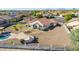 Aerial view of home with a pool, BBQ, mature landscaping, and desert rock at 1443 N Poppy St, Casa Grande, AZ 85122