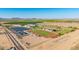 Wide aerial shot of local schools and athletics facilities, including fields, tracks, and solar panel arrays at 1443 N Poppy St, Casa Grande, AZ 85122