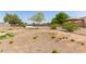 Large backyard featuring a BBQ, gazebo, mature tree, and gravel landscaping at 1443 N Poppy St, Casa Grande, AZ 85122