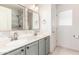 Bathroom featuring double sink vanity with tiled backsplash and modern fixtures at 1443 N Poppy St, Casa Grande, AZ 85122