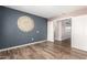 Bedroom with wood floors and a large sunburst decoration at 1443 N Poppy St, Casa Grande, AZ 85122