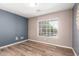 Bedroom with wood floors, light walls, and a large window at 1443 N Poppy St, Casa Grande, AZ 85122