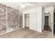 Bedroom featuring white ceiling fan, brick accent wall, and closet with sliding doors at 1443 N Poppy St, Casa Grande, AZ 85122
