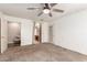 Bedroom featuring a ceiling fan, carpeted floor and an ensuite bath at 1443 N Poppy St, Casa Grande, AZ 85122