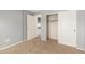 Bedroom featuring closet with sliding doors, neutral walls, and carpeted flooring at 1443 N Poppy St, Casa Grande, AZ 85122