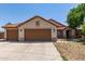 Charming single-story home featuring a terracotta roof, neutral stucco, and a spacious three-car garage at 1443 N Poppy St, Casa Grande, AZ 85122