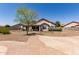 Charming home exterior with mature tree, desert landscaping, and brick paver accents at 1443 N Poppy St, Casa Grande, AZ 85122
