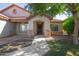 Charming single-story home with stone accents, desert landscaping, and a cozy covered porch entrance at 1443 N Poppy St, Casa Grande, AZ 85122