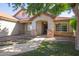 Welcoming single-story home with stone accents, desert landscaping, and a cozy covered porch entrance at 1443 N Poppy St, Casa Grande, AZ 85122