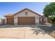 Charming single-story home featuring a three-car garage, desert landscaping and a red tile roof at 1443 N Poppy St, Casa Grande, AZ 85122