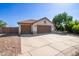 Attractive single-story home showcasing a three-car garage, desert landscaping, and a red tile roof at 1443 N Poppy St, Casa Grande, AZ 85122