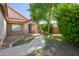Inviting single-story home with well-maintained landscaping, a covered porch and desert plants at 1443 N Poppy St, Casa Grande, AZ 85122