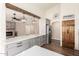 Modern kitchen with gray cabinets, quartz countertops, and a rustic wood pantry door at 1443 N Poppy St, Casa Grande, AZ 85122