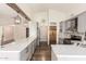 Spacious kitchen featuring white countertops, stainless steel appliances, and a rustic pantry door at 1443 N Poppy St, Casa Grande, AZ 85122