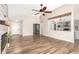 Open-concept living space with hardwood floors connecting to the kitchen and dining area at 1443 N Poppy St, Casa Grande, AZ 85122