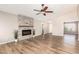 Bright living room with hardwood floors, a modern electric fireplace, and an elegant ceiling fan at 1443 N Poppy St, Casa Grande, AZ 85122