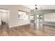 Open-concept living space with hardwood floors connecting to the kitchen and dining area at 1443 N Poppy St, Casa Grande, AZ 85122
