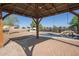 Covered pergola overlooking a sparkling pool, creating a perfect outdoor entertaining space at 1443 N Poppy St, Casa Grande, AZ 85122
