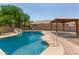 Sparkling pool with rock waterfall feature and gazebo providing shade at 1443 N Poppy St, Casa Grande, AZ 85122