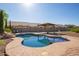 Sparkling pool with rock features and a covered patio offering a refreshing escape in the backyard at 1443 N Poppy St, Casa Grande, AZ 85122
