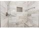 Bathroom featuring shower with tiled walls, a built-in niche, and seating at 1443 N Poppy St, Casa Grande, AZ 85122