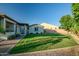 Expansive backyard with lush green grass and charming exterior architecture at 15803 W Almeria Rd, Goodyear, AZ 85395