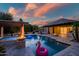 A backyard oasis featuring a sparkling pool, lush greenery, and an inviting outdoor space to relax and unwind at 15803 W Almeria Rd, Goodyear, AZ 85395