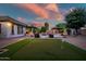 Enjoy outdoor living with a putting green, pool, spa, and outdoor kitchen at 15803 W Almeria Rd, Goodyear, AZ 85395